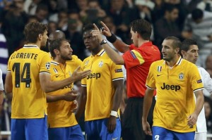 Juventus' Chiellini leaves the pitch after being sent off as his team mates argue with referee during their Champions League soccer match against Real Madrid in Madrid