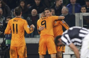 Real Madrid's Cristiano Ronaldo celebrates with his teammates Karim Benzema and Gareth Bale after scoring against Juventus during their Champions League soccer match at Juventus stadium in Turin